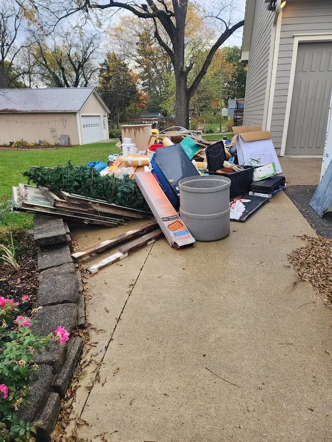 Dumpster being loaded with debris for Residential Dumpster Rental in Manor
